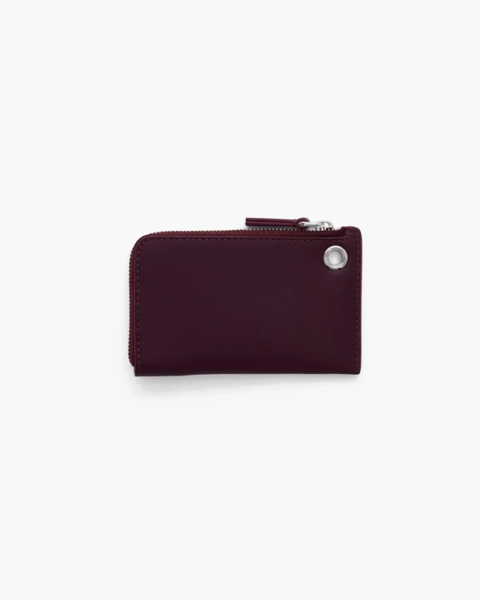 Cartera con cremallera superior y charms